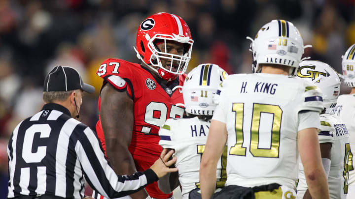 Nov 25, 2023; Atlanta, Georgia, USA; Georgia Bulldogs defensive lineman Warren Brinson (97) reacts after a tackle over Georgia Tech Yellow Jackets running back Jamal Haynes (11) in the second quarter at Bobby Dodd Stadium at Hyundai Field. Mandatory Credit: Brett Davis-USA TODAY Sports
