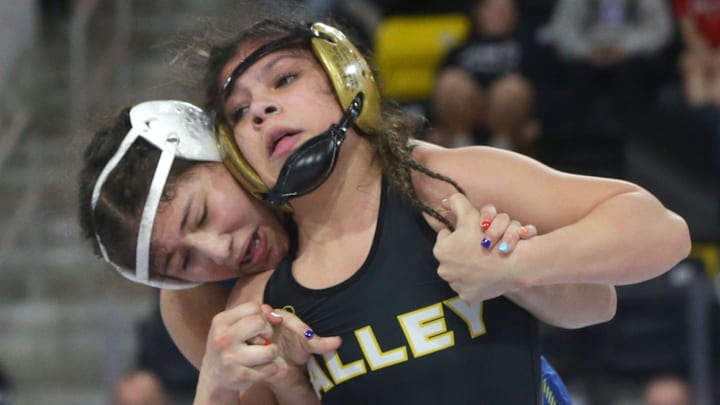Apple Valley's Cassandra Gonzales tries to get out of a hold by Wahlert Dubuque's Bella Miller Friday, Dec. 1, 2023 at the Dan Gable Donnybrook wrestling tournament at Xtream Arena in Coralville, Iowa. Apple Valley's Cassandra Gonzales tries to get out of a hold by Wahlert Dubuque's Bella Miller Friday, Dec. 1, 2023 at the Dan Gable Donnybrook wrestling tournament at Xtream Arena in Coralville, Iowa.