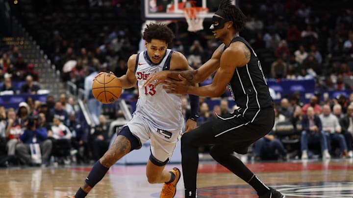 Feb 24, 2025; Washington, District of Columbia, USA; Washington Wizards guard Jordan Poole (13) drives to the basket as Brooklyn Nets center Nic Claxton (33) defends in the second half at Capital One Arena. Mandatory Credit: Geoff Burke-Imagn Images