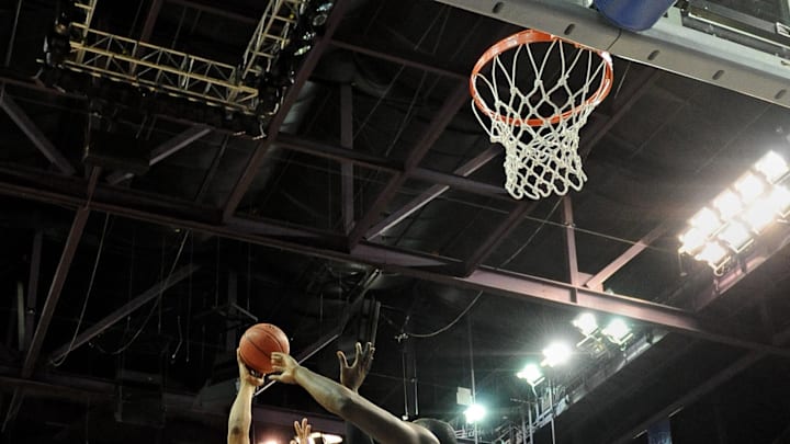 Mar. 10, 2012; Las Vegas, NV, USA; Louisiana Tech Bulldogs guard Brandon Gibson (2) puts up a shot against the New Mexico State Aggies center Hamidu Rahman (32) during the first half of the finals of the WAC tournament at the Orleans Arena. Mandatory Credit: Jennifer Stewart-Imagn Images.