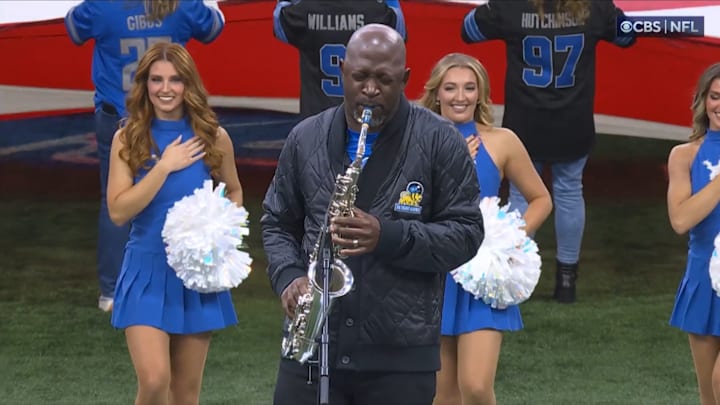 Saxophonist Mike Phillips plays "The Star-Spangled Banner" before the Detroit Lions host the Chicago Bears on Thanksgiving Day.