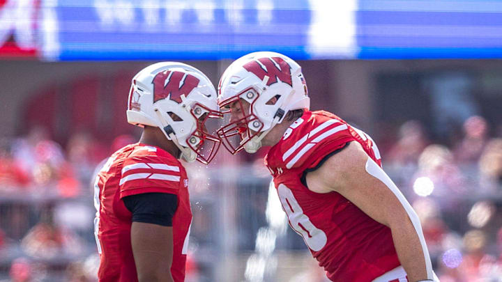 Wisconsin Badgers C.J. Williams (4) and Tawee Walker (3) headbutt at the end of a timeout during the game at Camp Randall Stadium in Madison, Wis. on Saturday, September 14, 2024.