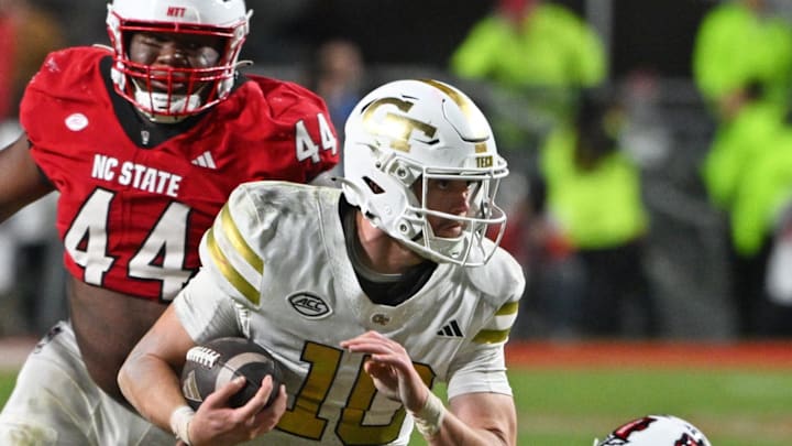 Nov 1, 2025; Raleigh, North Carolina, USA;  Georgia Tech Yellow Jackets quarterback Haynes King (10) runs the ball against the NC State Wolfpack during the fourth quarter at Carter-Finley Stadium. Mandatory Credit: Zachary Taft-Imagn Images