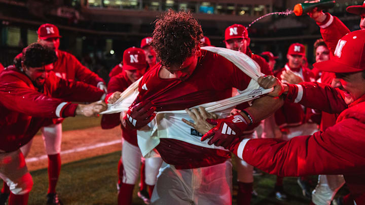 Case Sanderson has his jersey pulled off by his teammates after hitting a walk-off home run in extra innings to beat Michigan State.