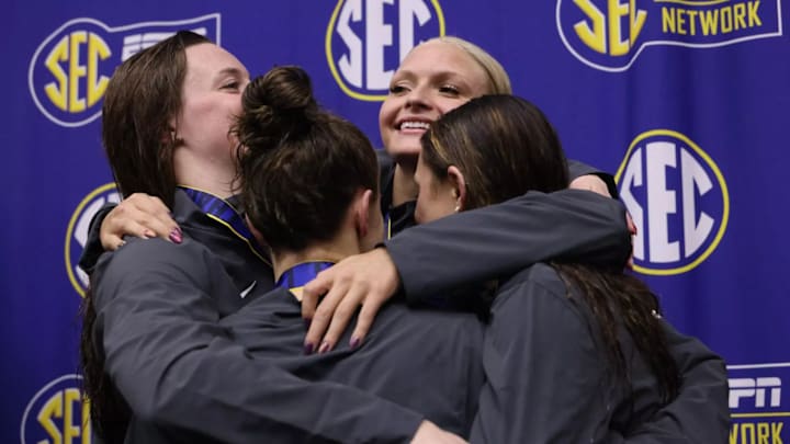 Alabama swimmers celebrate a podium finish at the 2026 SEC championships in Knoxville.