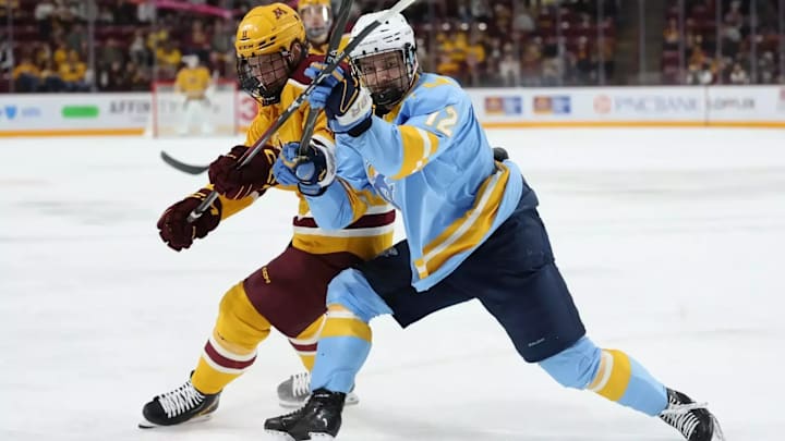 Brennan Nelson of Long Island fights off a Minnesota player to the pick during the 2026 signature victory for the Sharks. Brennan Nelson of Long Island fights off a Minnesota player to the pick during the 2026 signature victory for the Sharks.