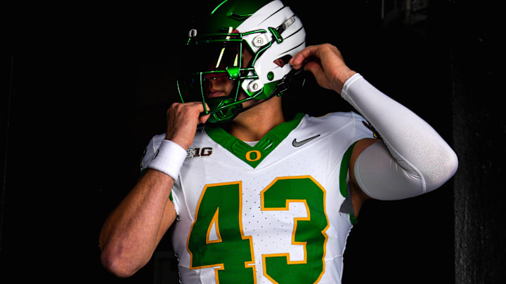 Luke Basso models Oregon Duck Football's uniforms for their game against the Iowa Hawkeyes.