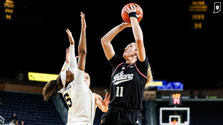 Indiana's Karoline Striplin shoots over the Michigan defense Wednesday at the Crisler Center. Indiana's Karoline Striplin shoots over the Michigan defense Wednesday at the Crisler Center.