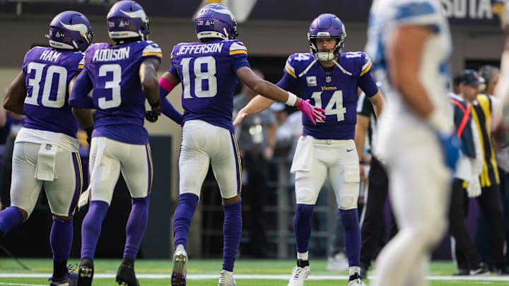 Sam Darnold (14) celebrating with Justin Jefferson (18), Jordan Addison (3) and C.J. Ham (30)