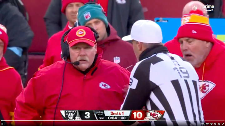 Chiefs head coach Andy Reid speaks with a referee on the sidelines.