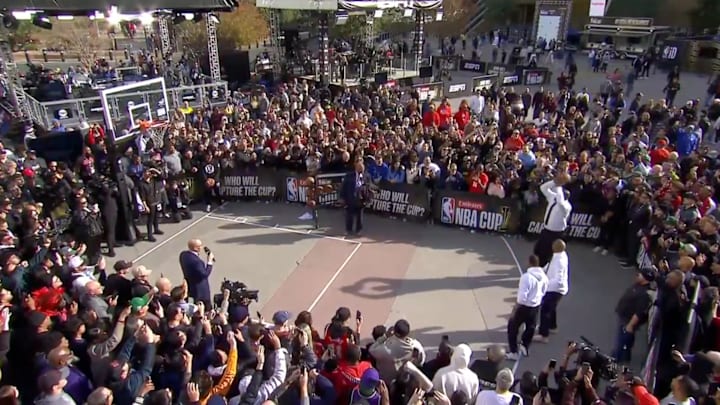 Shaquille O’Neal and Stephen A. Smith take part in a three-point contest in front of a gathered crowd.