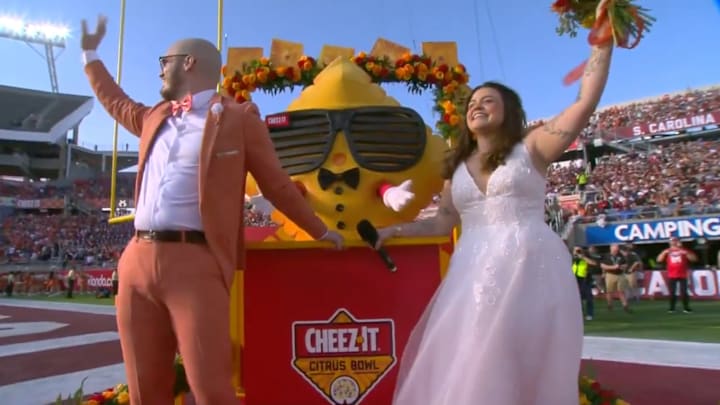 A couple gets married at the Cheez-It Citrus Bowl.