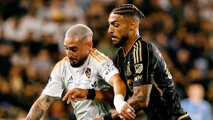 Diego Fagundez (left) and Denis Bouanga battled in Saturday night's history-making El Tráfico matchup. 