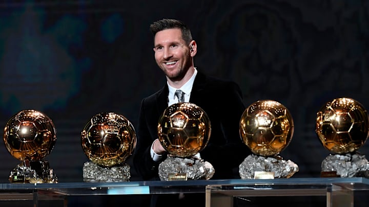 Lionel Messi with just some of the Ballons d’Or he has won.