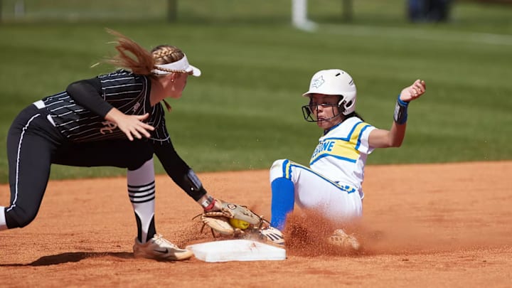 A player from Limestone University slides into second base safely.