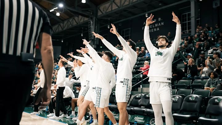 Tulane men's basketball celebrates a three