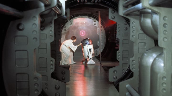 Princess Leia (Carrie Fisher) loads the plans for the Death Star battle station with a plea for help to Obi-Wan Kenobi into R2-D2 on the Rebel Blockade Runner.