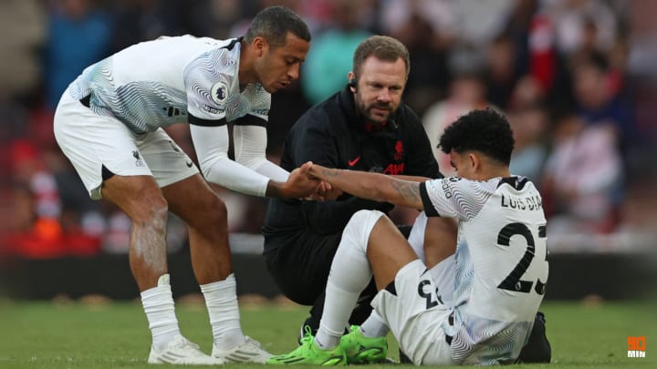Thiago attempts to help the stricken Luis Diaz to his feet