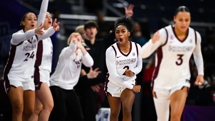 Leila Wells celebrating with the bench in the background and Mackenzie Nelson in the foreground. 