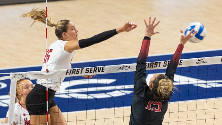 Nebraska middle blocker Andi Jackson spikes the ball and scores a point for the Huskers during the first set of the AVCA First Serve.