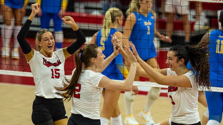 From left, Andi Jackson, Bergen Reilly and Virginia Adriano celebrate Thursday night during the Huskers' sweep of UCLA.