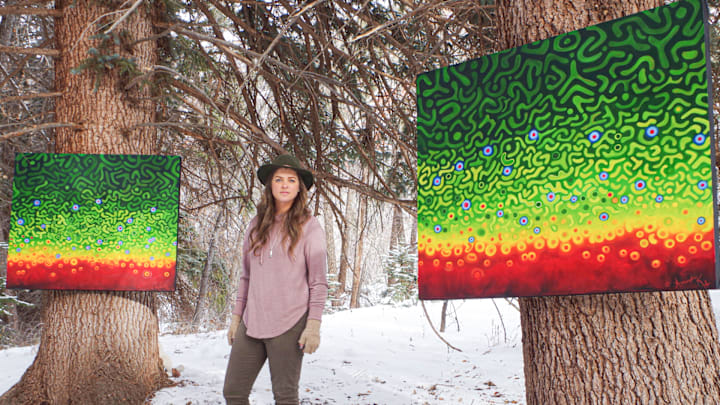 Mandy Hertzfeld pictured with her paintings in Colorado. Hertzfeld is a fly fishing guide and painter whose work is informed by time spent on the water.