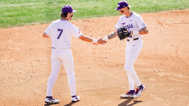 TCU infielders Lucas Franco and Cole Cramer high-five before the beginning of an inning. 
