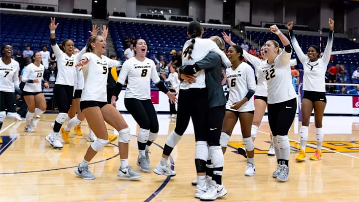 Teammates rally around senior Jordan Iliff after she sealed Missouri Volleyball's victory over Illinois.
