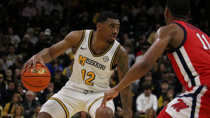 Jan. 25, 2025; Columbia, Missouri, USA; Missouri Tigers guard Tony Perkins (12) sizes up Ole Miss guard Matthew Murrell (11) in a win at Mizzou Arena.