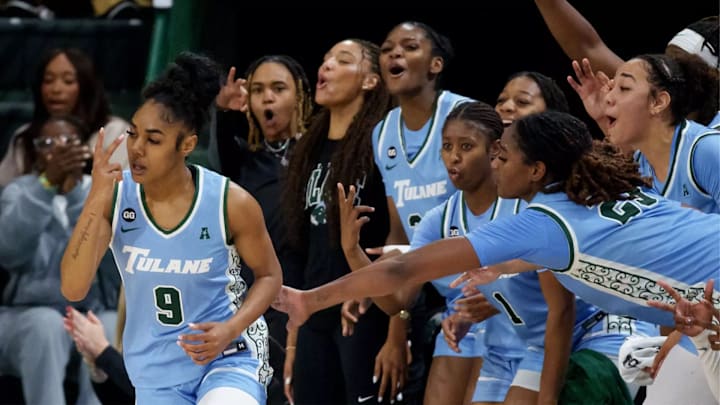 Tulane women's basketball player Kendall Sneed reacts to making a shot as do her teammates