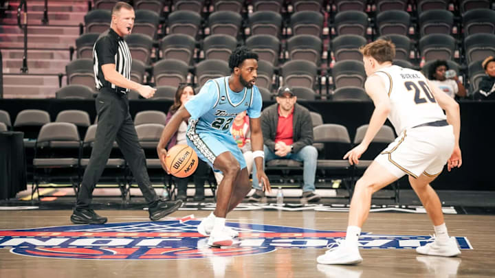 Tulane guard Asher Woods drives with the ball