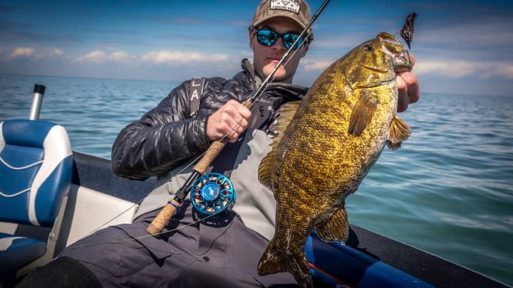 Guide Jacob Thomason with a barely hooked smallmouth bass from Lake Ontario. Guide Jacob Thomason with a barely hooked smallmouth bass from Lake Ontario.