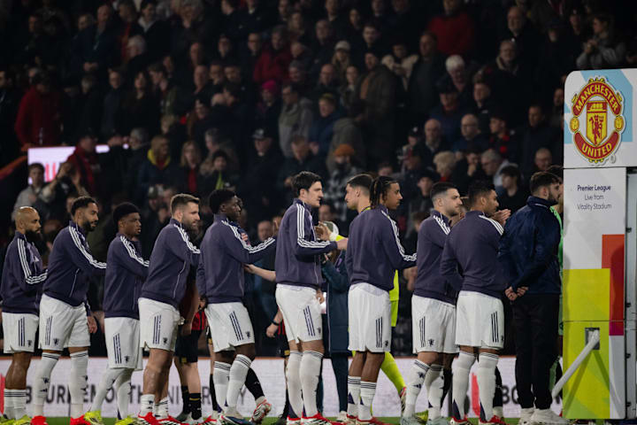 Manchester United squad members preparing for post-match handshakes. Manchester United squad members preparing for post-match handshakes.