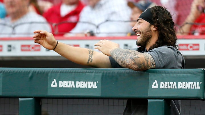 Injured Cincinnati Reds second baseman Jonathan India (6) smiles as he cheers.