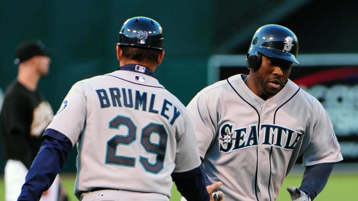 Seattle Mariners outfielder Milton Bradley (right) is congratulated by third base coach Mike Brumley (29) after hitting a two-run home run during the first inning against the Oakland Athletics at Oakland-Alameda County Coliseum in 2010.