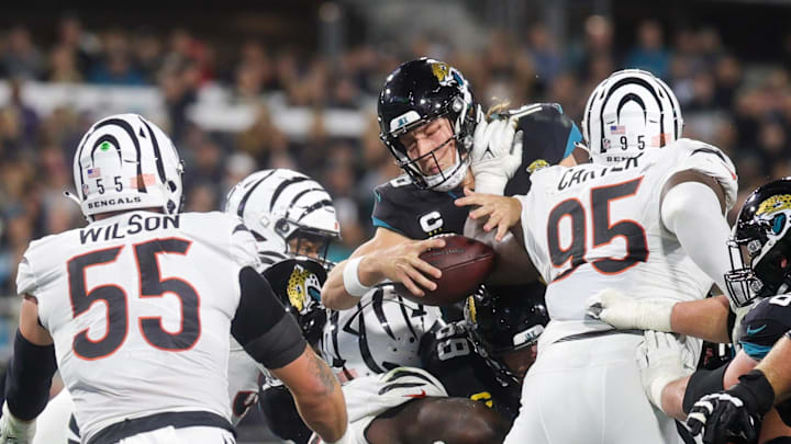 Dec 4, 2023; Jacksonville, Florida, USA;  Jacksonville Jaguars quarterback Trevor Lawrence (16) reaches out to score a touchdown against the Cincinnati Bengals in the third quarter at EverBank Stadium. Mandatory Credit: Nathan Ray Seebeck-Imagn Images