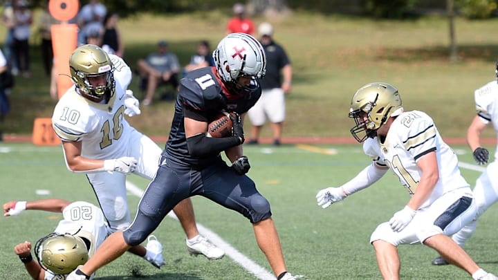 Saint James' Xavier Colbert gains yards after a catch against Paul VI.