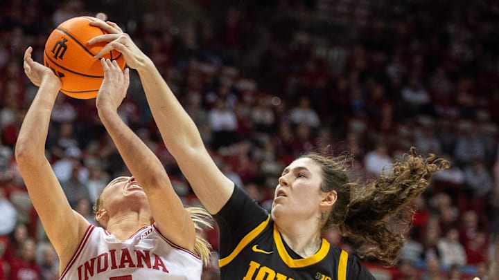 Indiana's Lenée Beaumont (5) is blocked by Iowa's Ava Heiden (5) during the Indiana versus Iowa womens basketball game at Simon Skjodt Assembly Hall on Sunday, Jan. 11, 2026.