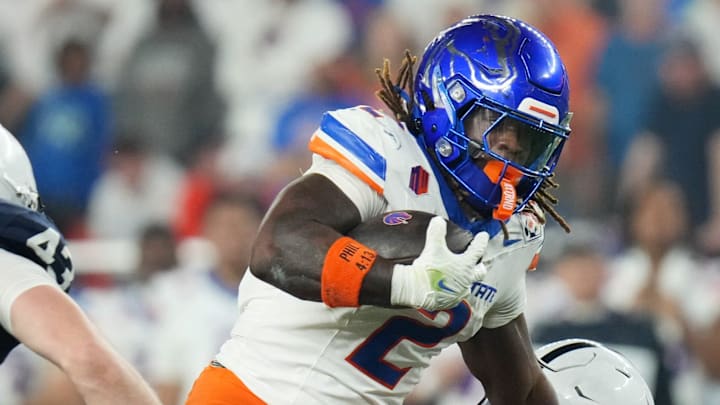 Dec 31, 2024; Glendale, AZ, US; Boise State Broncos running back (2) Ashton Jeanty tries to break past Penn State Nittany Lions safety Zakee Wheatley (6) during their Vrbo Fiesta Bowl matchup at State Farm Stadium. Dec 31, 2024; Glendale, AZ, US; Boise State Broncos running back (2) Ashton Jeanty tries to break past Penn State Nittany Lions safety Zakee Wheatley (6) during their Vrbo Fiesta Bowl matchup at State Farm Stadium.