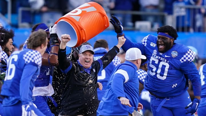 Dec 31, 2019; Charlotte, North Carolina, USA;  Kentucky Wildcats douse Coach Mark Stoops after the second half against the Virginia Tech Hokies at the Belk Bowl at Bank of America Stadium. Mandatory Credit: Jim Dedmon-Imagn Images