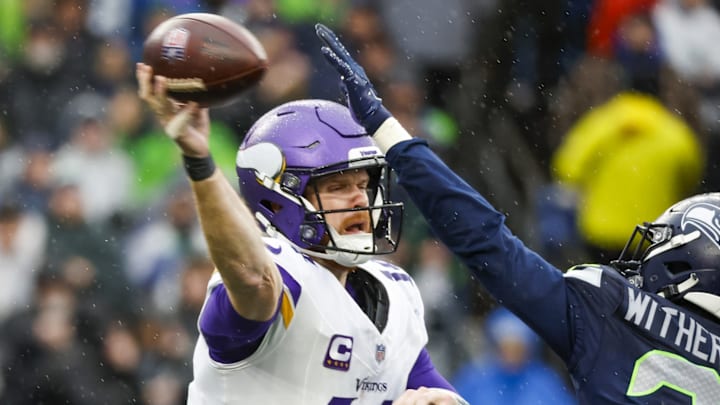 Dec 22, 2024; Seattle, Washington, USA; Minnesota Vikings quarterback Sam Darnold (14) passes against the Seattle Seahawks during the second quarter at Lumen Field. Dec 22, 2024; Seattle, Washington, USA; Minnesota Vikings quarterback Sam Darnold (14) passes against the Seattle Seahawks during the second quarter at Lumen Field.