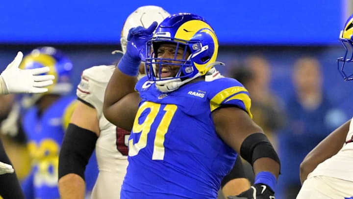 Dec 28, 2024; Inglewood, California, USA;  Los Angeles Rams defensive tackle Kobie Turner (91) celebrates after sackiing Arizona Cardinals quarterback Kyler Murray (1) in the second half at SoFi Stadium. Mandatory Credit: Jayne Kamin-Oncea-Imagn Images