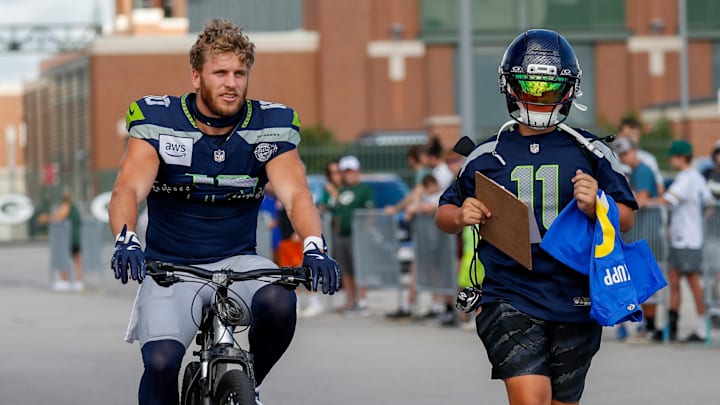 Seattle Seahawks wide receiver Cooper Kupp (10) rides a bicycle to a joint practice with the Green Bay Packers on Thursday, August 21, 2025, at Lambeau Field in Green Bay, Wis. 