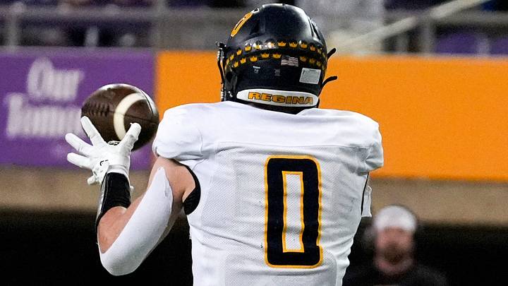 Iowa City Regina’s Tate Wallace (0) makes a catch Nov. 20, 2025 during the Class 1A state football championship against the West Lyon Wildcats at the UNI-Dome in Cedar Falls, Iowa. Iowa City Regina’s Tate Wallace (0) makes a catch Nov. 20, 2025 during the Class 1A state football championship against the West Lyon Wildcats at the UNI-Dome in Cedar Falls, Iowa.