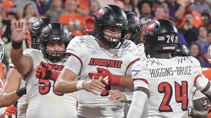 Nov 2, 2024; Clemson, South Carolina, USA; Louisville Cardinals quarterback Tyler Shough (9) celebrates with receiver Ahmari Huggins-Bruce (24) after scoring against the Clemson Tigers during the second quarter at Memorial Stadium. Mandatory Credit: Ken Ruinard-Imagn Images