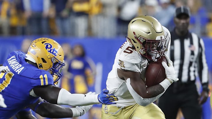 Nov 16, 2023; Pittsburgh, Pennsylvania, USA; Boston College Eagles running back Kye Robichaux (5) runs with the ball past Pittsburgh Panthers linebacker Bangally Kamara (11) during the first quarter at Acrisure Stadium. Mandatory Credit: Charles LeClaire-Imagn Images