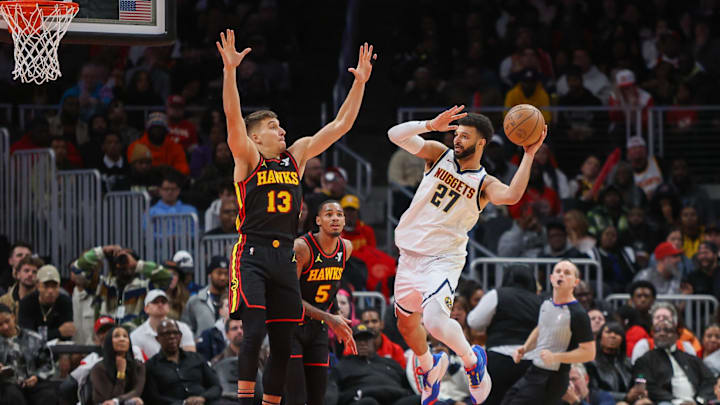 Dec 11, 2023; Atlanta, Georgia, USA; Denver Nuggets guard Jamal Murray (27) passes around Atlanta