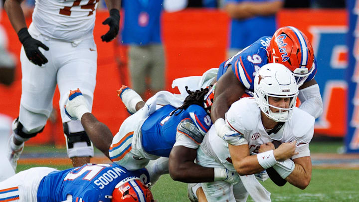 Oct 4, 2025; Gainesville, Florida, USA; Florida Gators defensive end Tyreak Sapp (94) and linebacker Myles Graham (5) sack Texas Longhorns quarterback Arch Manning (16) during the second half at Ben Hill Griffin Stadium. Mandatory Credit: Matt Pendleton-Imagn Images