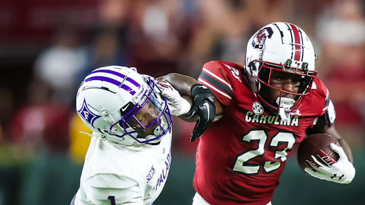 Sep 9, 2023; Columbia, South Carolina, USA; South Carolina Gamecocks running back Djay Braswell (23) attempts to get around Furman Paladins cornerback Travis Blackshear (1) during the second half at Williams-Brice Stadium. Mandatory Credit: Jeff Blake-Imagn Images