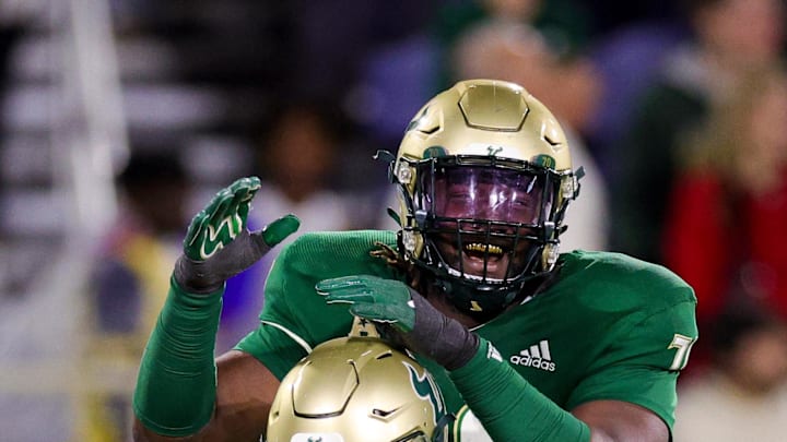 Dec 21, 2023; Boca Raton, FL, USA;  South Florida Bulls offensive lineman RJ Perry (70) congratulates wide receiver Sean Atkins (38) after scoring a touchdown against the Syracuse Orange in the third quarter during the RoofClaim.com Boca Raton Bowl at FAU Stadium. Mandatory Credit: Nathan Ray Seebeck-USA TODAY Sports
